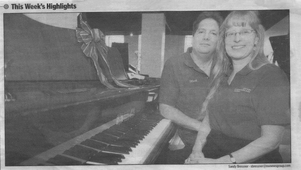 Picture of Alice Alviani and Mark MacLeod in front of a piano, from a newspaper from 2006.