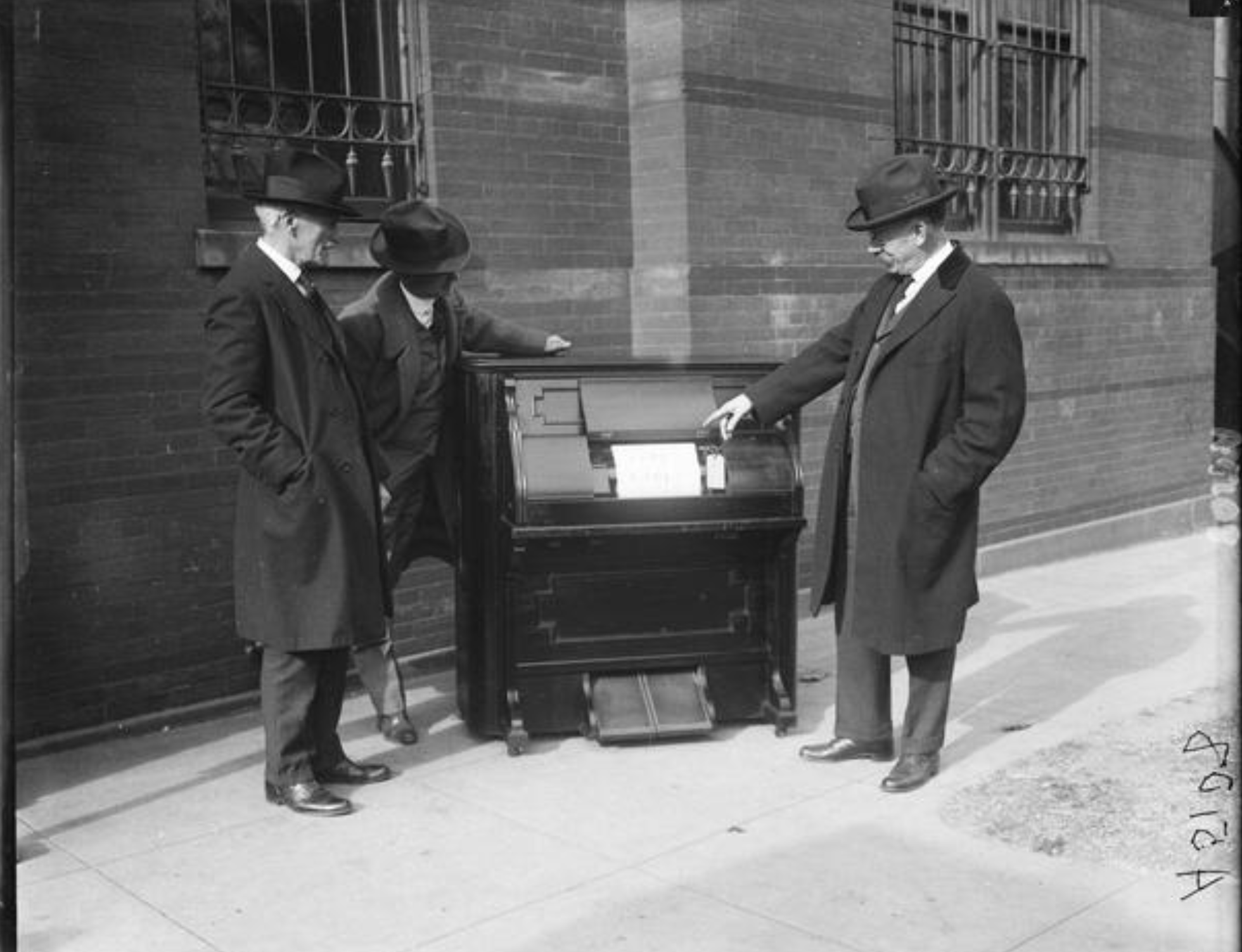 Original Pianola self playing piano system being presented to Smithsonian Museum as gift by Edwin S. Votey the inventor (right, pointing) on December 7, 1922.