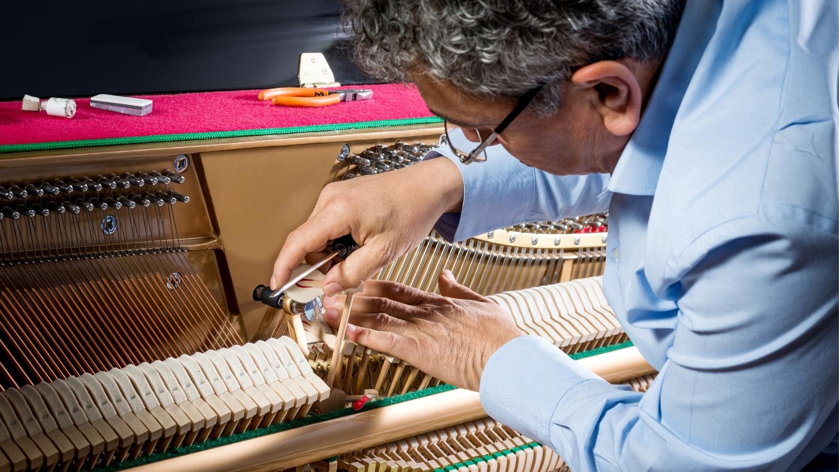 Piano Technician Working on a Piano