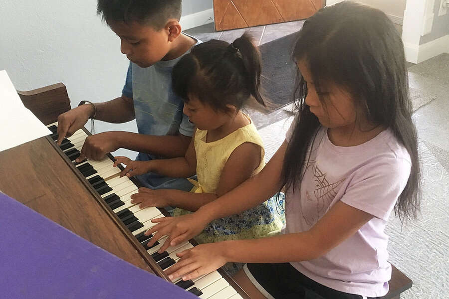 Children Playing on Donated Piano